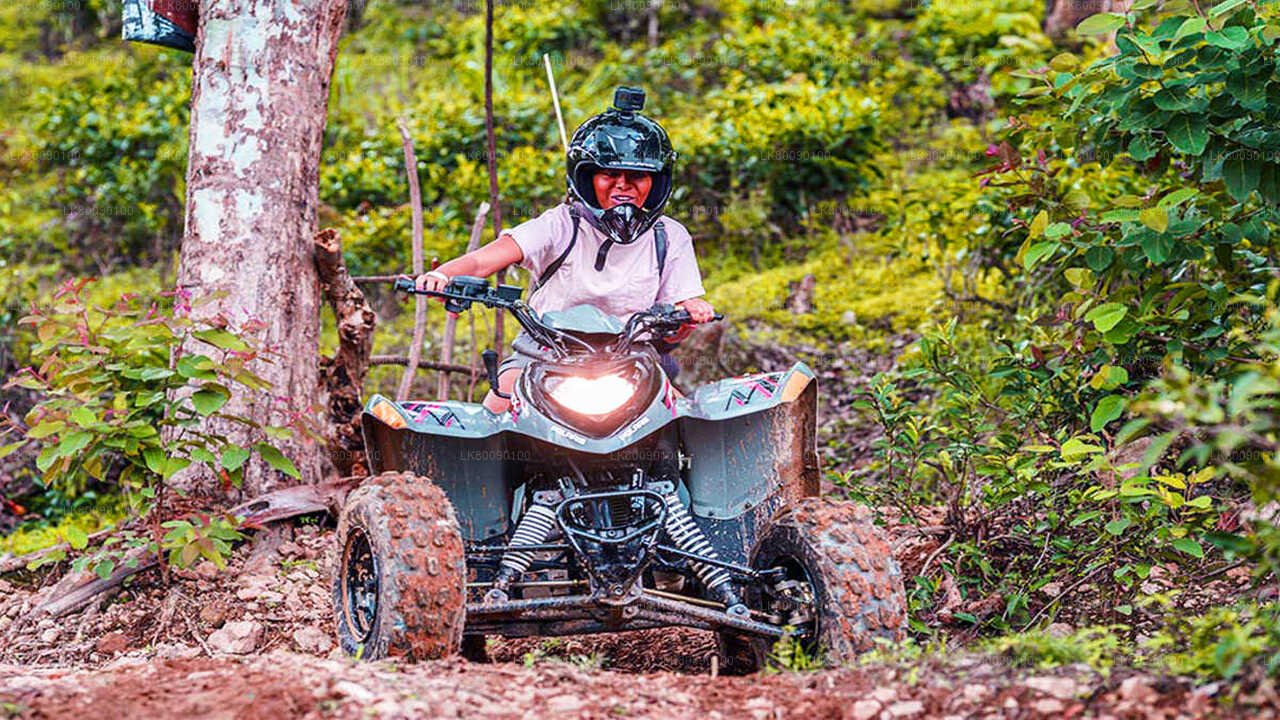 A person riding an ATV through the mountains of Ella
